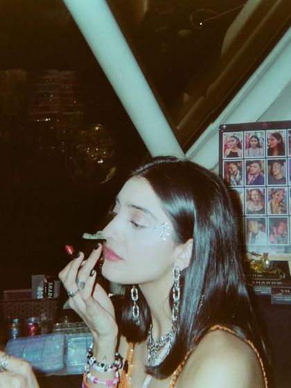 A candid film photo of me getting ready at a glitter bar. It’s all about the details and getting into the spirit of the party.