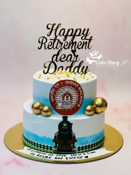 A special retirement cake for a father who worked in the Indian Railways. This two-tier cake features the railway logo and a train track design along the bottom.