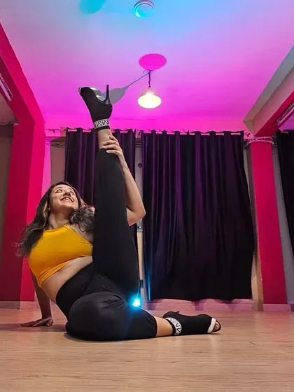 Holding a flexible pose that highlights a dancer's strength and control. The space allows you to capture stunning stills that showcase your skills and artistry.