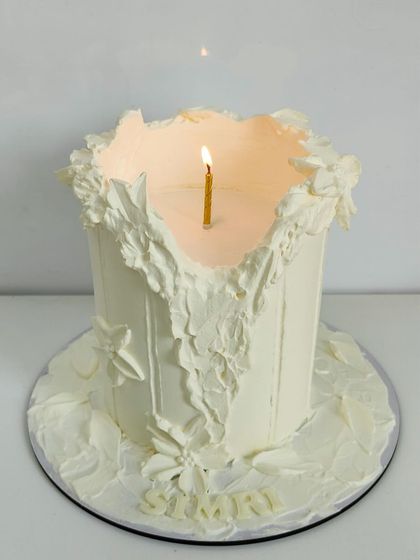 The candle cake, lit from within, creating a warm and beautiful glow that truly brings the design to life.