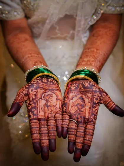 The beauty of a rich, dark henna stain after the paste comes off. This bridal design features classic bride and groom figures, known as dulha-dulhan mehendi, symbolizing the start of their new journey together.