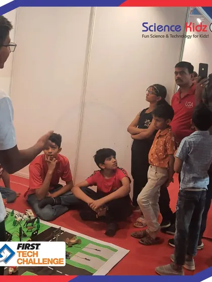 Mentorship in action. Our lead mentor guides the FTC team as they prepare to demonstrate their "Soul City" project. This hands-on guidance is crucial for refining their presentation and technical details.