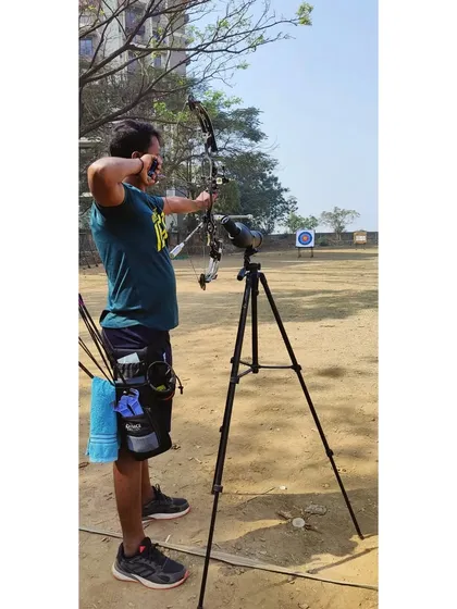 Focus is everything in archery. This archer demonstrates intense concentration as he aims his compound bow during a training session.