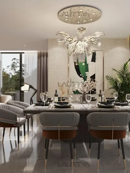 This open-plan living and dining area is inspired by modern luxury. The dining space features a minimalist table setting, soft upholstered chairs, and a sculptural chandelier that adds an artistic flair.