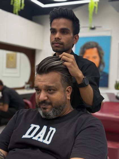 Here I am styling the final look of his "big reveal" transformation. The salt and pepper hair combined with a modern cut creates a very premium and classy style.