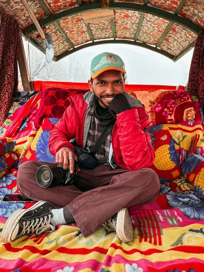 This is me in my element, camera in hand on a shikara in Kashmir. Every trip is a new story, and I’m always ready to capture it.