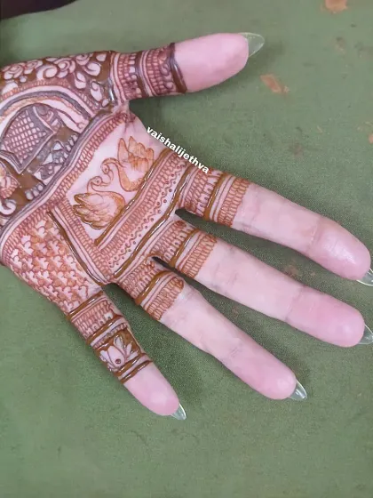 A close-up of the palm section of the design. This shot highlights the delicate swan and elephant motifs.