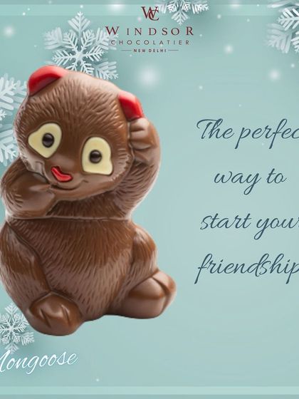 This chocolate figure, which resembles a panda or mongoose, is captured in a cute, bashful pose, made from finely detailed milk chocolate.