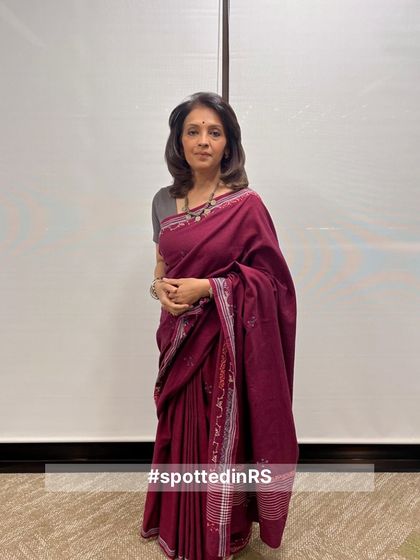 This customer wears a deep maroon handwoven saree, showcasing its rich color and beautiful border. It’s a look of timeless elegance and grace.