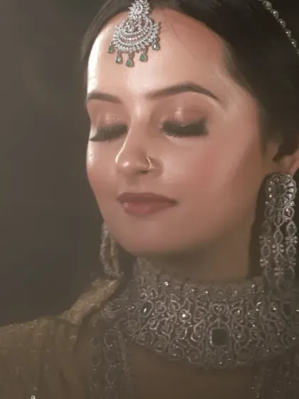 This portrait uses dramatic, low-key lighting to create a moody and artistic feel. The light beautifully sculpts the bride's features and highlights the sparkle of her diamond jewelry.