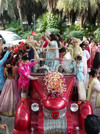 The groom's baraat is a full celebration. We organize the procession with elements like a vintage car, music, and plenty of space for dancing.