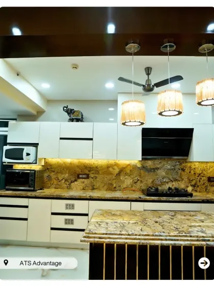 An open kitchen with a stunning granite countertop that extends to the backsplash. The island provides extra prep space, making it perfect for someone who loves to cook.