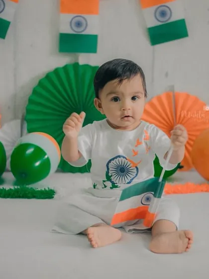 Surrounded by the colors of the flag, this little one is ready to celebrate.