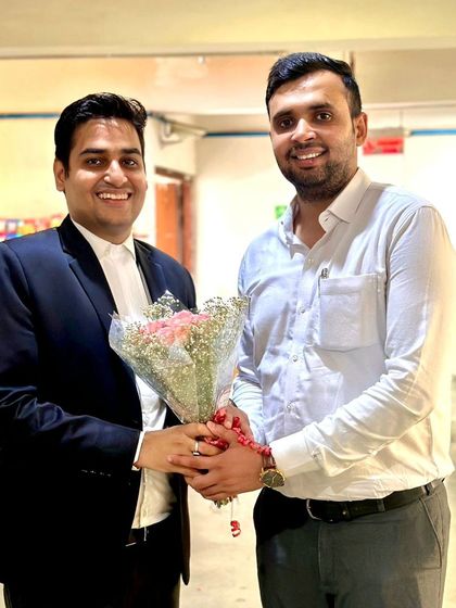 Receiving a bouquet from a colleague, likely during a bar association event. Building good relationships within the legal fraternity is important to me.