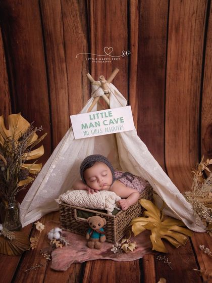 A little explorer in his cozy boho tent. The sign "Little Man Cave" adds a playful touch to this rustic and adventurous setup.