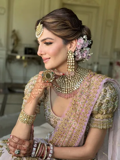 A bridal look is more than just a hairstyle; it's a crown. This soft, textured messy bun, adorned with fresh flowers, is a favorite I teach. It shows how to create volume and romance while ensuring the style is secure and comfortable for a long wedding day.