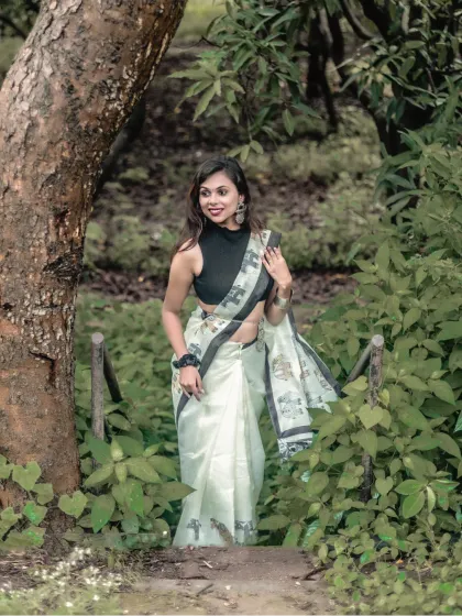 A confident pose amidst nature. The model walks down a path in a modern saree, blending contemporary style with a rustic setting.