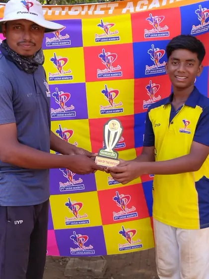 A smiling U-14 player in his yellow team jersey accepts the Man of the Match award for his standout performance.