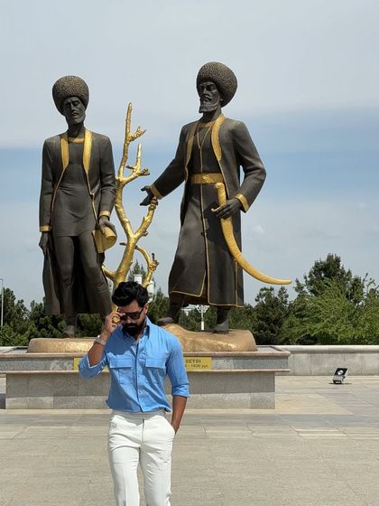 This shot captures the shirt's vibrant color against a backdrop of impressive statues, creating a powerful and stylish image.