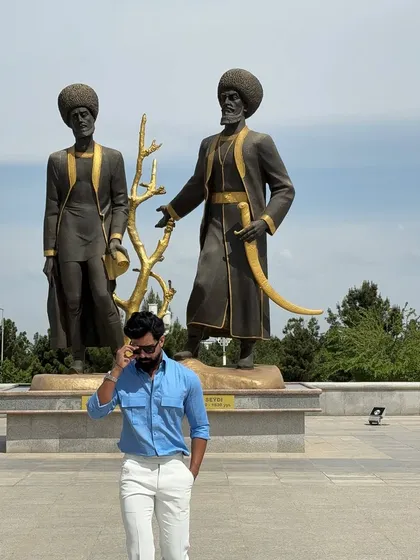 This shot captures the shirt's vibrant color against a backdrop of impressive statues, creating a powerful and stylish image.