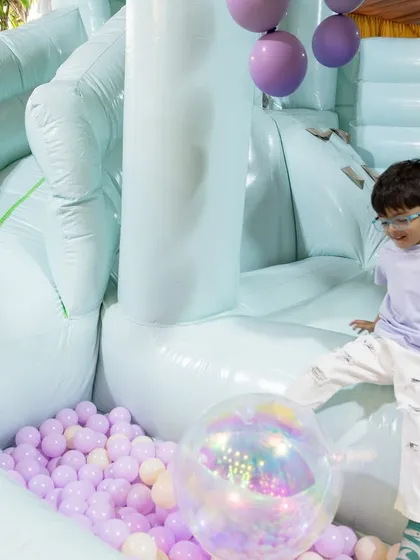 A young guest having a fantastic time in the mermaid-themed bouncy castle.