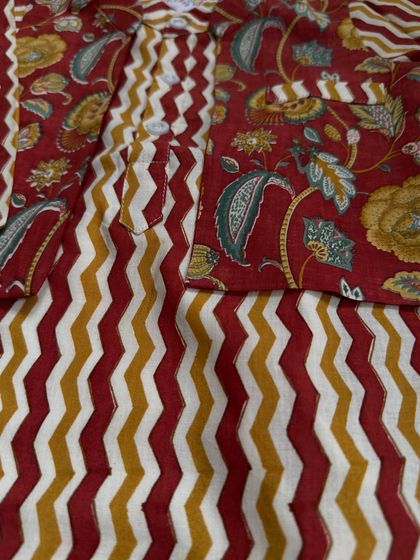 A detailed shot of the fabric from one of our boy's bandi sets, showing the mix of a rich floral print with a bold zigzag pattern.