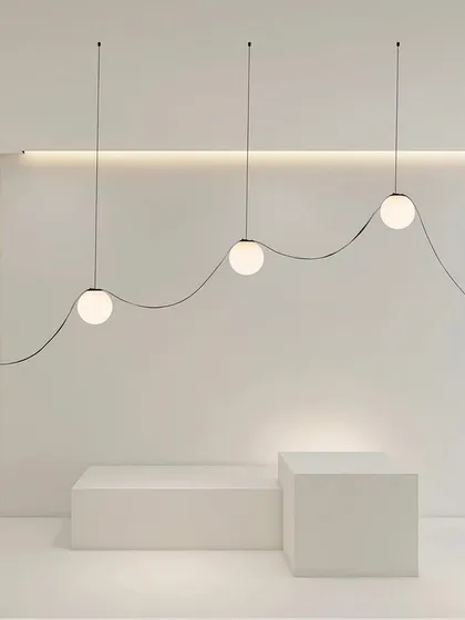 Our Braided Tape Series is showcased here in a minimalist, artistic installation. The flexible tape allows for creative, flowing designs, with spherical bulbs creating points of light along a graceful curve. This system is perfect for those who want to move beyond traditional fixtures and sculpt with light.