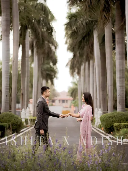 A classic pre-wedding pose with the couple holding hands along a beautiful, tree-lined avenue. This showcases our ability to create elegant and timeless couple portraits.