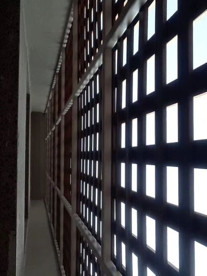 Looking through the Tipwood screen from a balcony. This perspective shows how the screen offers privacy from the outside while still allowing light and air to pass through.