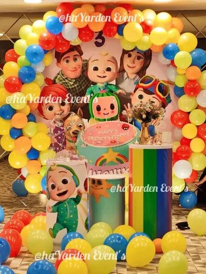 A closer look at the Cocomelon party setup, showing the vibrant colors and character details that make the theme so popular with young children.