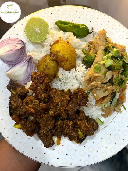 A simple, hearty meal of buff stir fry with potatoes, paired with a bamboo shoot eromba and fresh chilies.