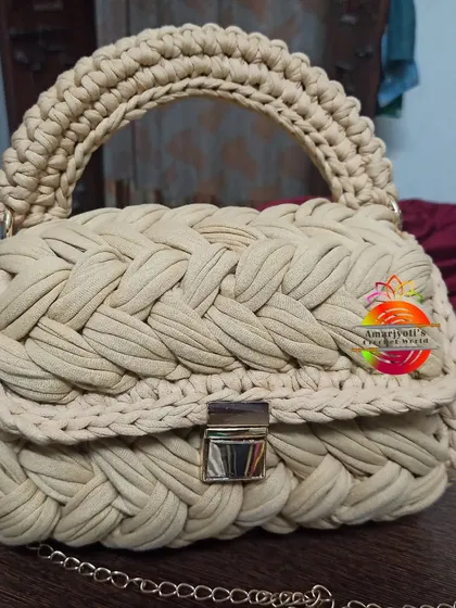 Another look at the beige handbag, showcasing its craftsmanship and the sturdy top handle. It's a perfect example of a handmade luxury item.