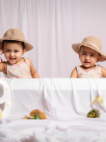These nine-month-old twins are two peas in a pod. We use simple props to highlight their adorable matching expressions and shared milestone.