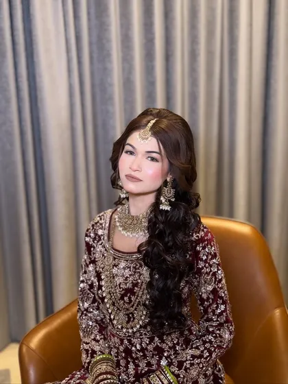 A portrait of the bride, showcasing her flawless makeup and elegant hairstyle. The nude lip and defined eyes create a modern and chic look.