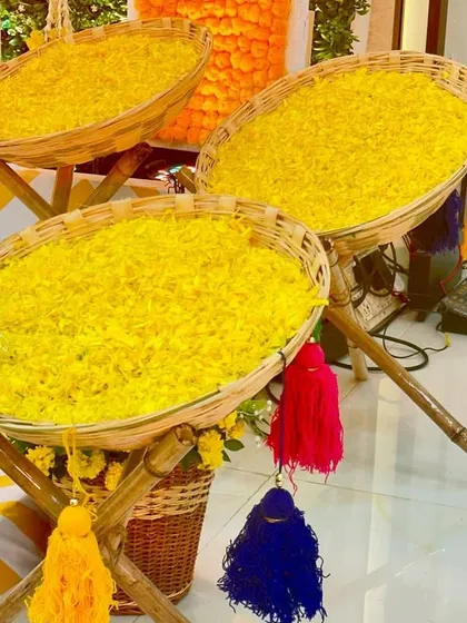 Baskets of fresh marigold petals ready for a 'Phoolon ki Holi' celebration, adding a fun and interactive element to the Haldi ceremony.