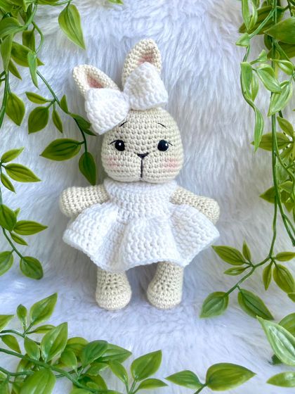 A pure white bunny doll, made as a special gift for a Holy Communion ceremony. Her simple white dress gives her a sacred and peaceful look.