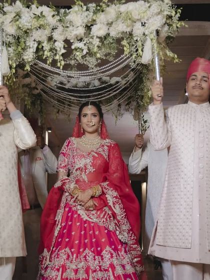 A full view of the bride's procession under a floral and pearl canopy, a beautiful tradition that we love to incorporate with our own design touches.