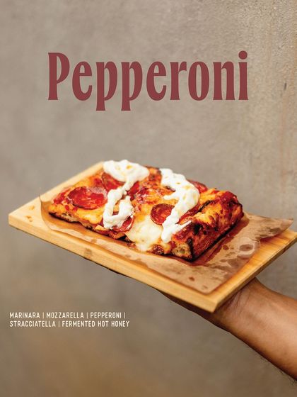 A spicy and sweet Pepperoni slice from our Romana menu, topped with stracciatella and fermented hot honey.