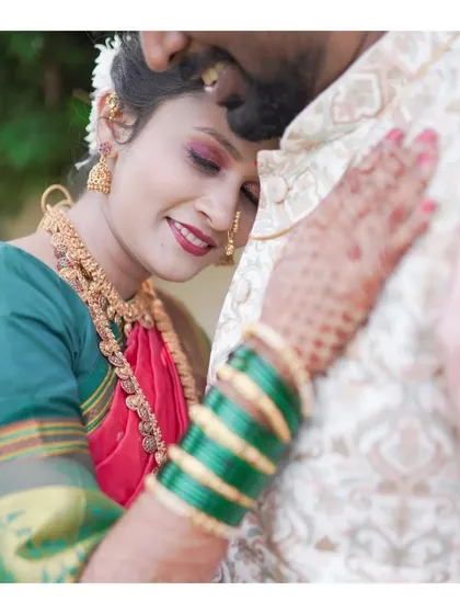 An intimate and tender moment between a newly married couple. The bride rests her head on the groom's chest, her eyes closed in contentment, showcasing the deep connection and love they share.