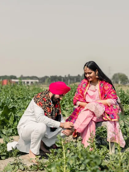 A tender moment in a rustic Punjabi field, capturing a traditional expression of love and care. We believe in telling stories that are authentic to your culture and roots.