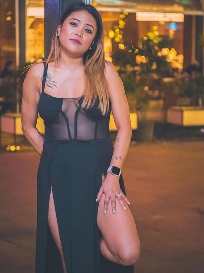 A guest posing by the Christmas lights.