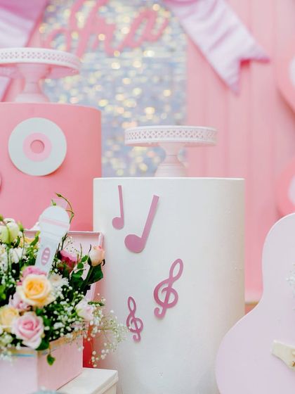 Details from the dance party, including music note cutouts, a mini microphone, and a pink guitar prop.