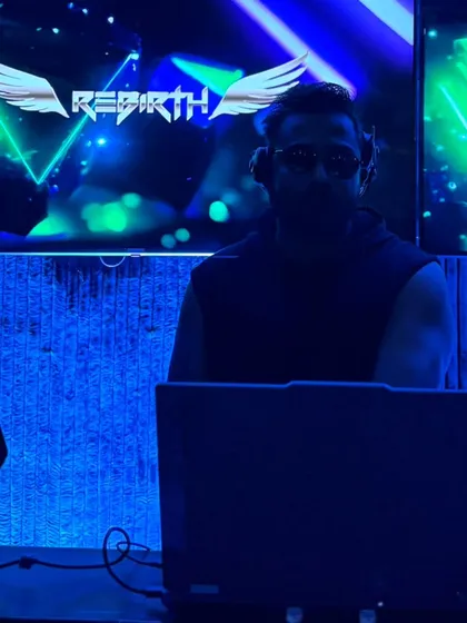 In the zone under the blue lights, with my 'Rebirth' logo on the screen. The club is my sanctuary, where I can be in my element and connect with the crowd through music.