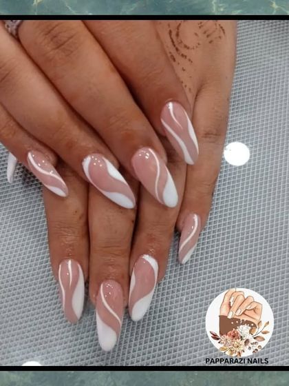 A beautiful abstract design with soft brown and white waves on long almond-shaped nails.