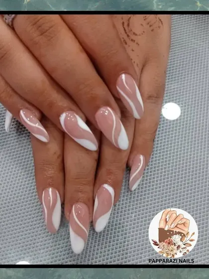 A beautiful abstract design with soft brown and white waves on long almond-shaped nails.