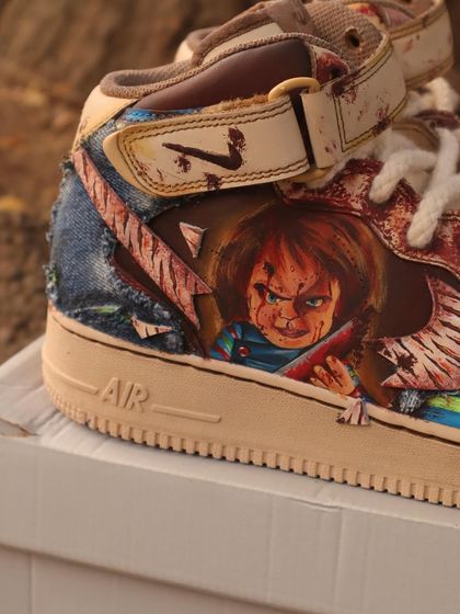 A detailed shot of the Chucky-themed AF1s. You can see the portrait of Chucky himself, complete with his menacing expression and signature knife. I love working on horror-themed designs.