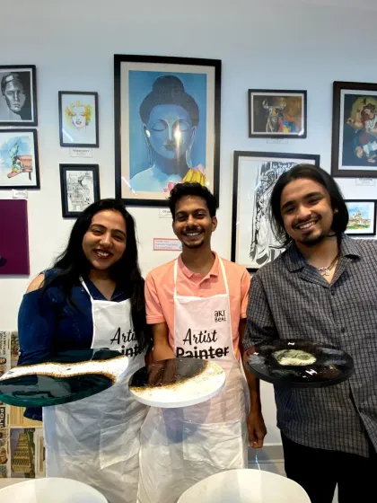 A group of friends smiling with their finished resin art pieces. My studio is a great place to gather, get creative, and make lasting memories together.