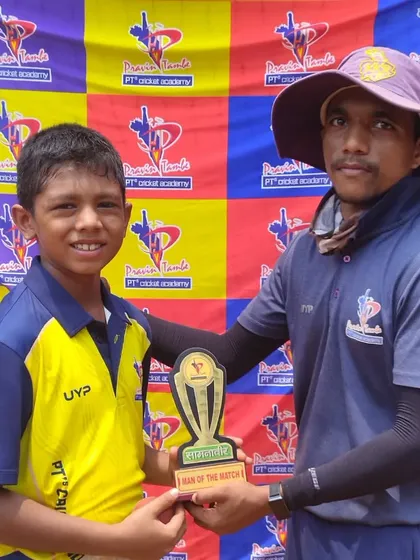 A coach presents a Man of the Match trophy to a young U-10 cricketer, recognizing his efforts in the game.