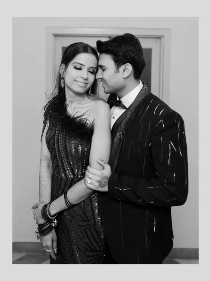 An elegant black and white portrait of the couple, their classic attire and loving embrace exuding timeless sophistication.