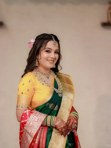 A close-up of the bride's happy face, with a pink flower in her hair adding a soft touch.